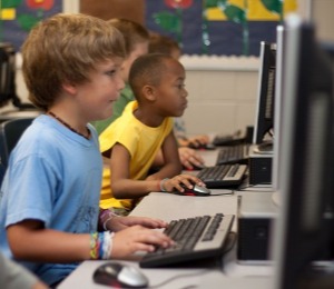 Two children working in a computer lab