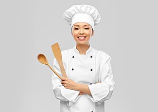 A young chef with cooking utensils