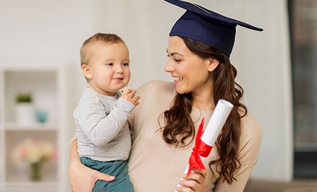 A young mom holding a child and diploma