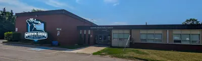 exterior picture of Merwin Greer Public School and their logo