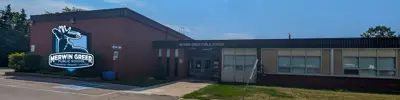 exterior picture of Merwin Greer Public School and their logo