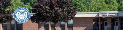 exterior picture of Havelock-Belmont Public School and their logo