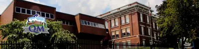exterior picture of Queen Mary Public School and their logo