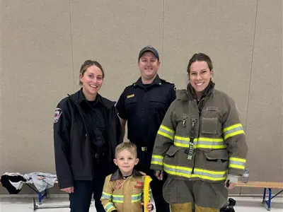 student standing in front of firemen