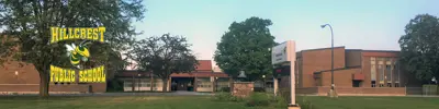 exterior picture of Hillcrest Public School and their logo