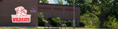 exterior picture of Warsaw Public School and their logo