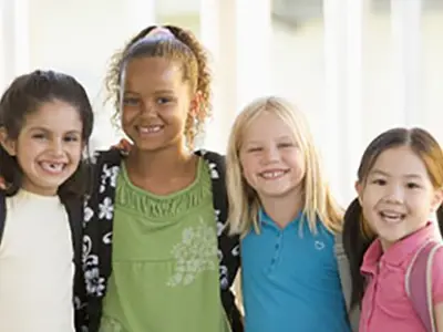 Four smiling kids embracing