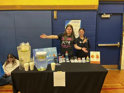 students standing in front of information booth