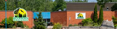 exterior picture of Buckhorn Public School and their logo