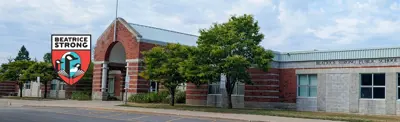 exterior picture of Beatrice Strong Public School and their logo