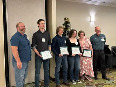 a group of students holding diplomas