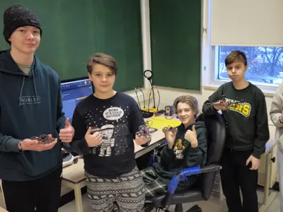 group of students holding drones