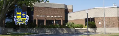 exterior picture of Clarke High School with the school logo