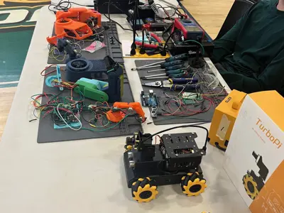 student sitting at a table with tools