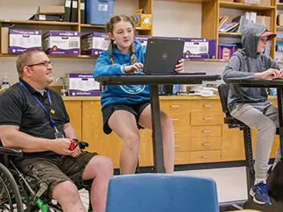Teacher in wheelchair with student 