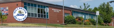 exterior picture of Millbrook/South Cavan Public School and their logo