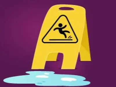 a water spill on the floor with a yellow caution sign