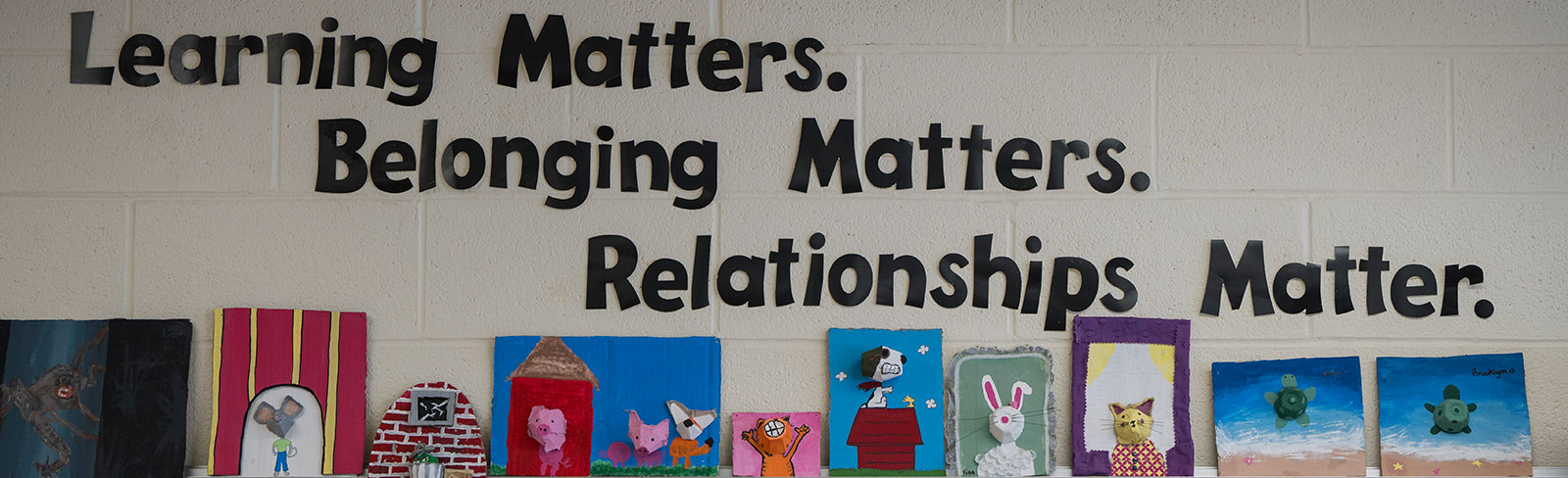a picture of a bulletin board at a school.  Learning Matters, Belonging Matters, Relationships Matter